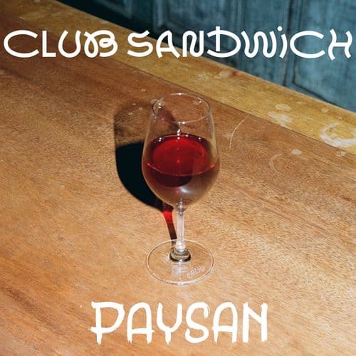 Glad of red wine with club sandwich and paysan logos
