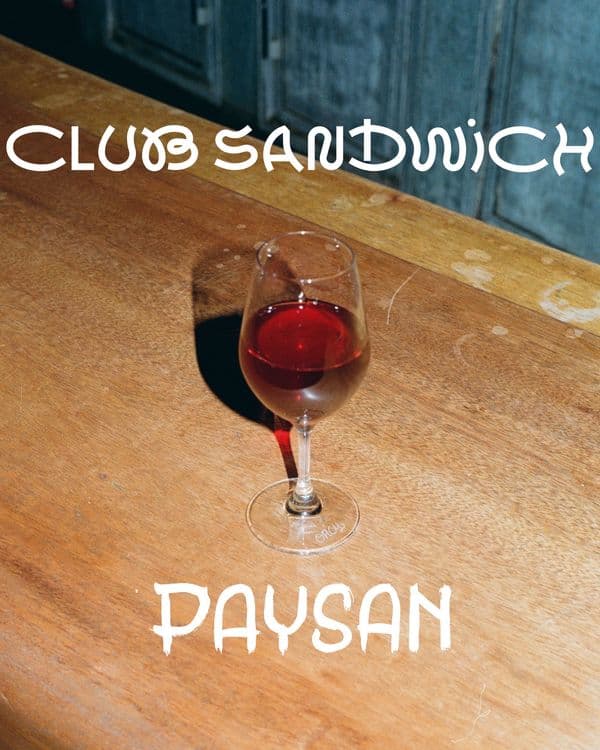 Glad of red wine with club sandwich and paysan logos